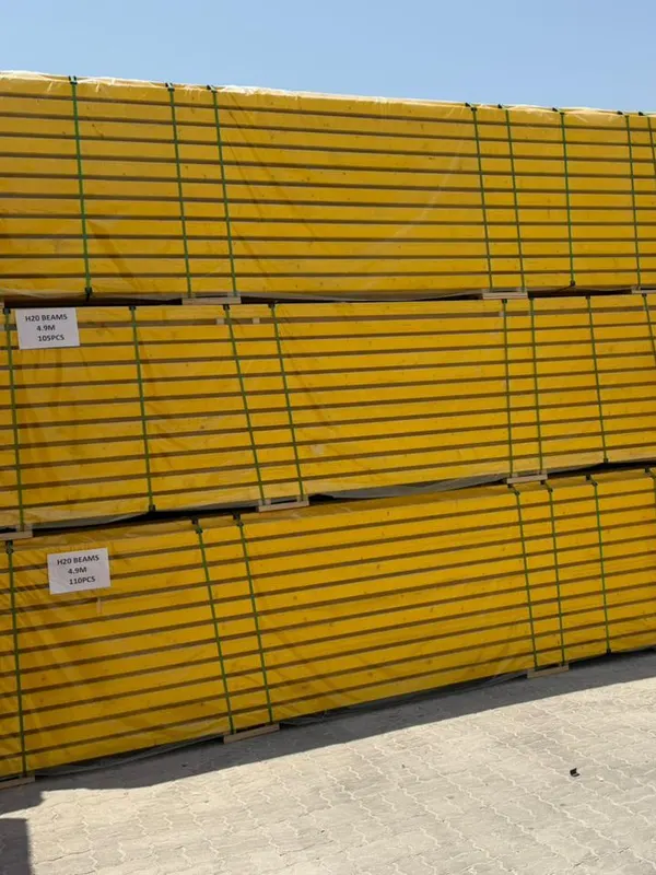 Strapped packs of H20 timber beams with labels showing length and piece count