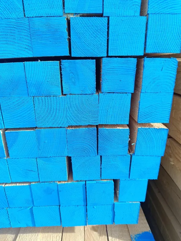 Close view of square whitewood sections with blue-painted ends